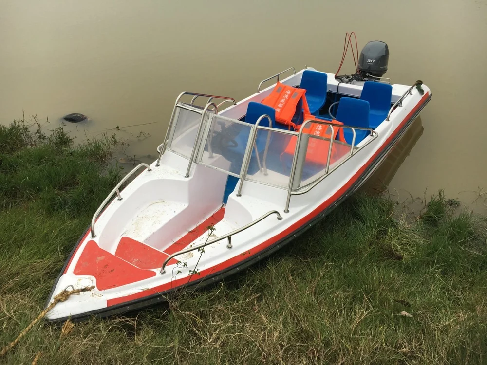 Yellow and red fiberglass motor boat, high-performance motor boat, durable fiberglass boat, watercraft for lakes and rivers, speed boat, commercial and leisure boat, multi-purpose marine boat
